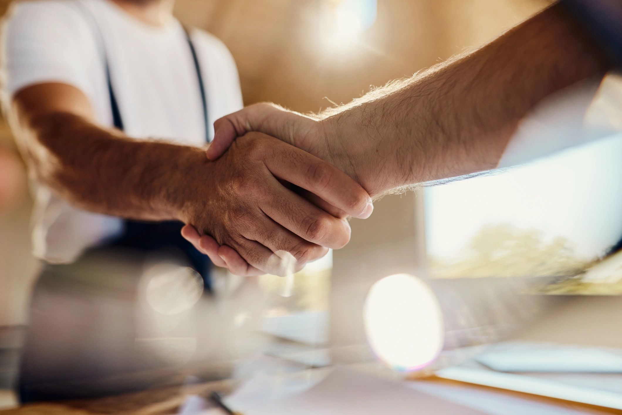 Handshake over documents to finalize an agreement