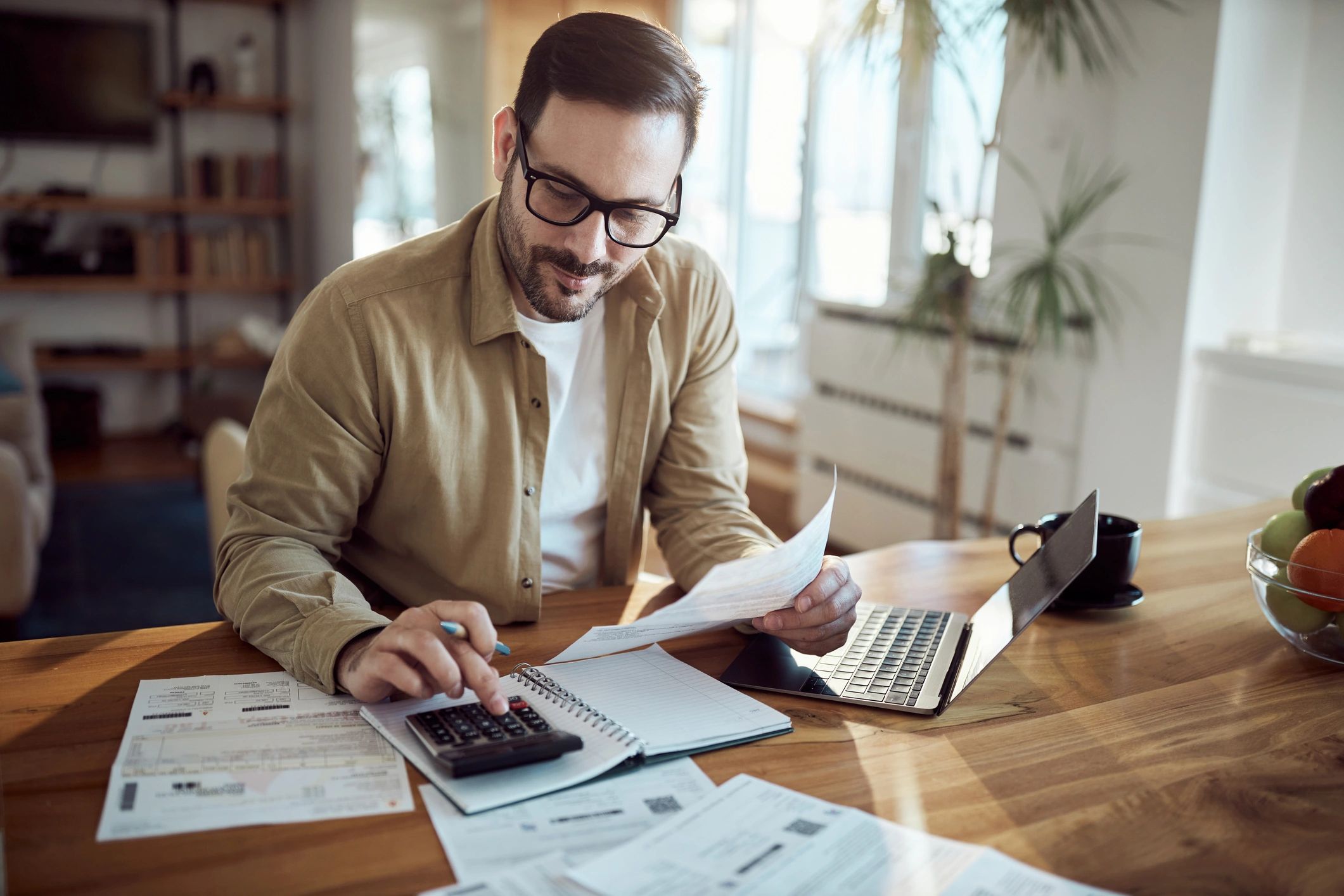 Investor reviewing finances with a calculator